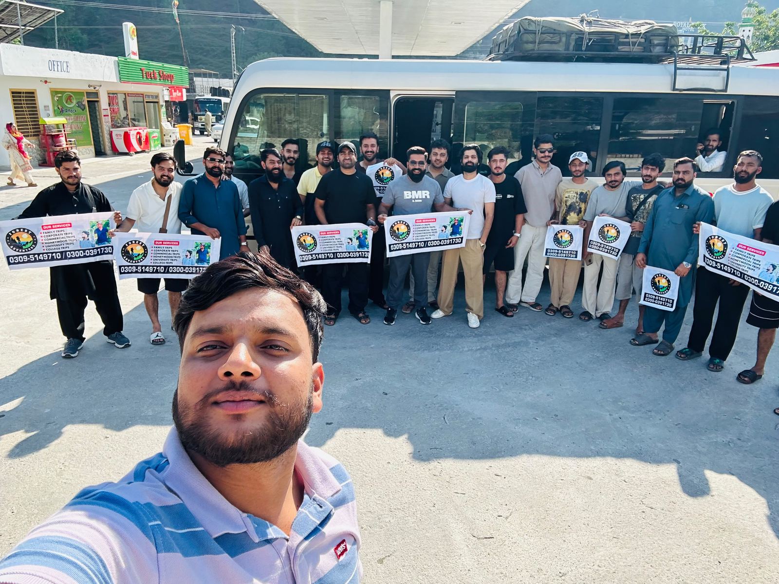 Danial Iqbal with a tour group holding Forest Adventures banners