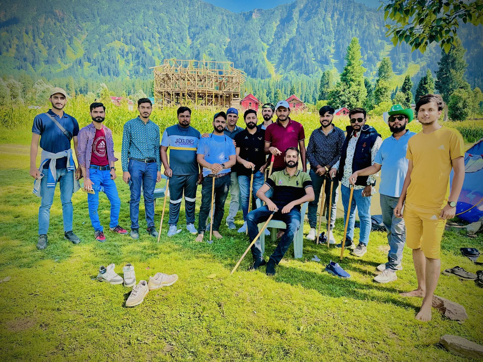 Group at a green meadow campsite near Nanga Parbat